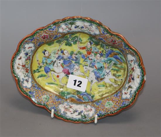 An early 20th century Chinese yellow ground oval dish, painted with warriors length 21cm